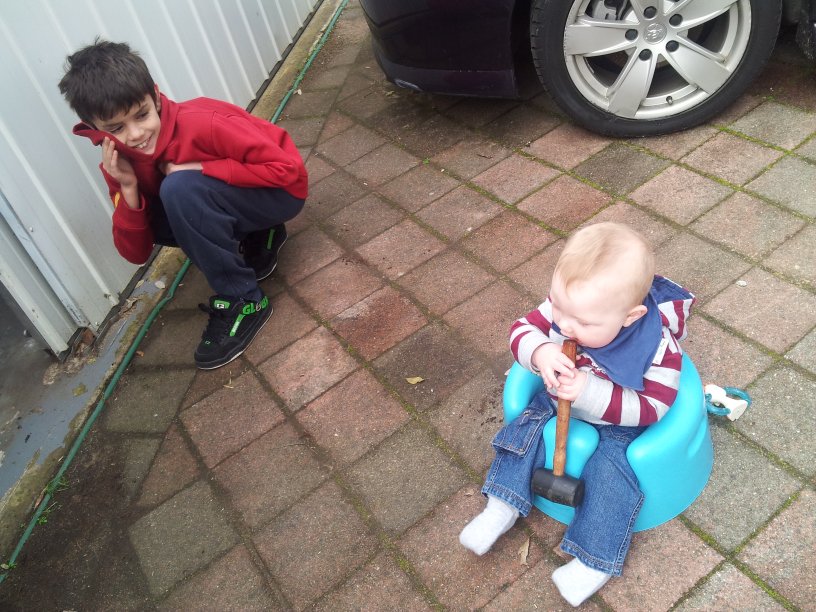 14 Gundowringa Ave - front yard - 12 July - Jason Torreni with Joseph eating a mallet.jpg